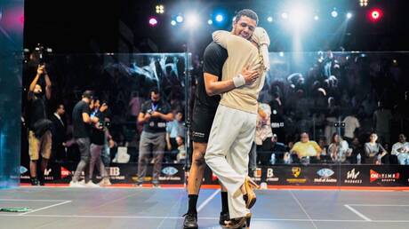 A touching scene... an Egyptian's mother shares her joy at winning the squash championship


